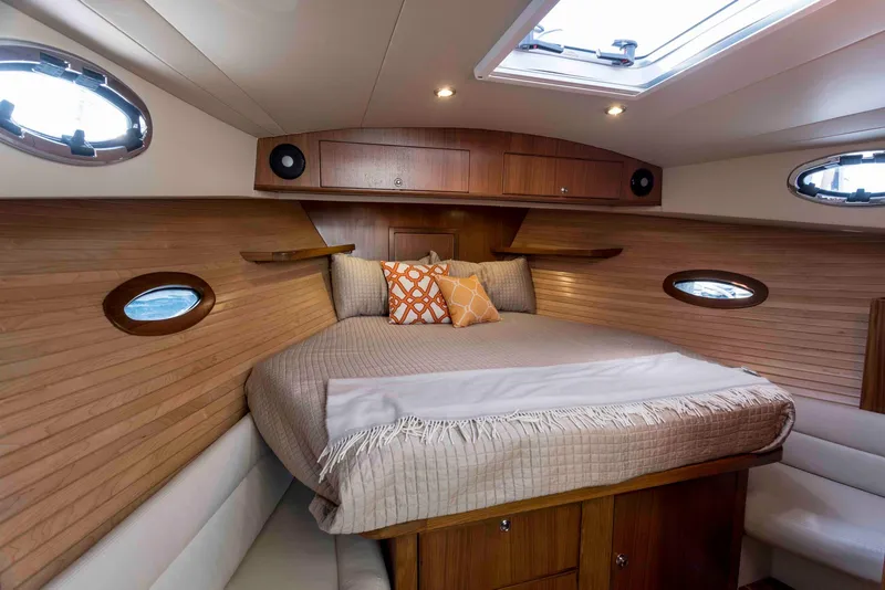 Slide: The Image of 2025 True North 39 Outboard Express boat on calm water. - 16