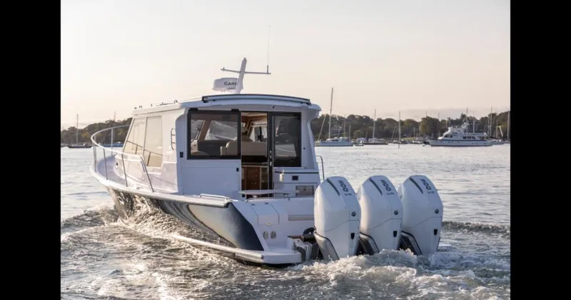 Slide: The Image of 2025 True North 39 Outboard Express cruising on calm waters. - 3