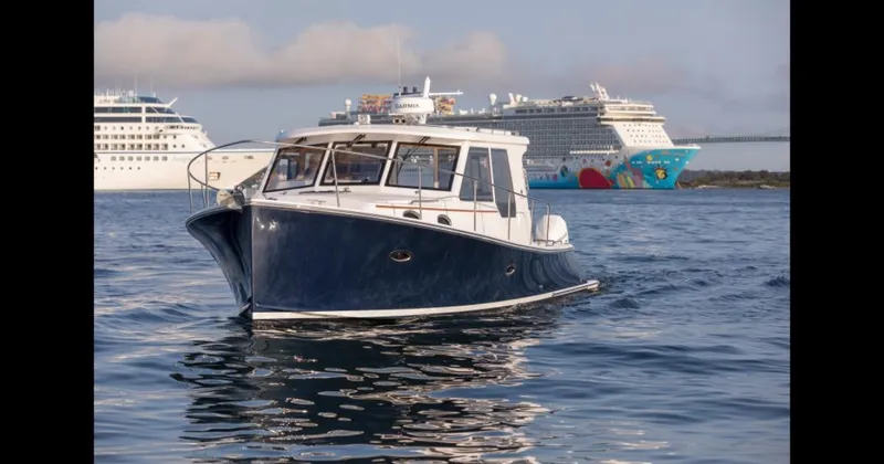 Slide: The Image of 2025 True North 39 Outboard Express cruising near a large bridge. - 4