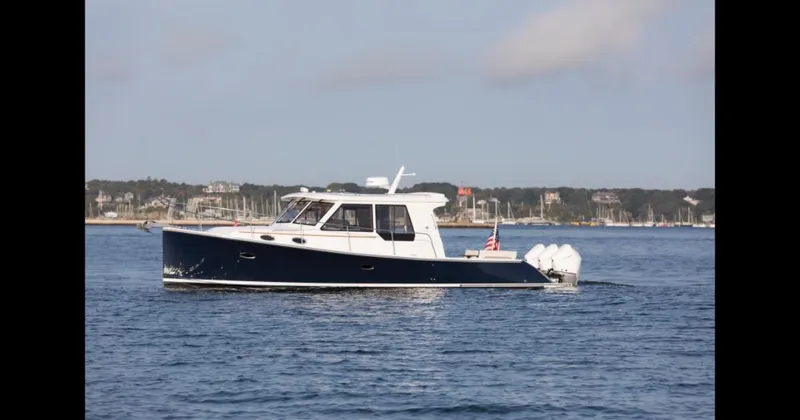 Slide: The Image of 2025 True North 39 Outboard Express cruising on a scenic waterway. - 7