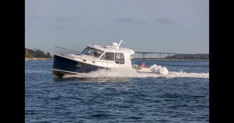 Slide: The Image of 2025 True North 39 Outboard Express cruising on open water. - 8