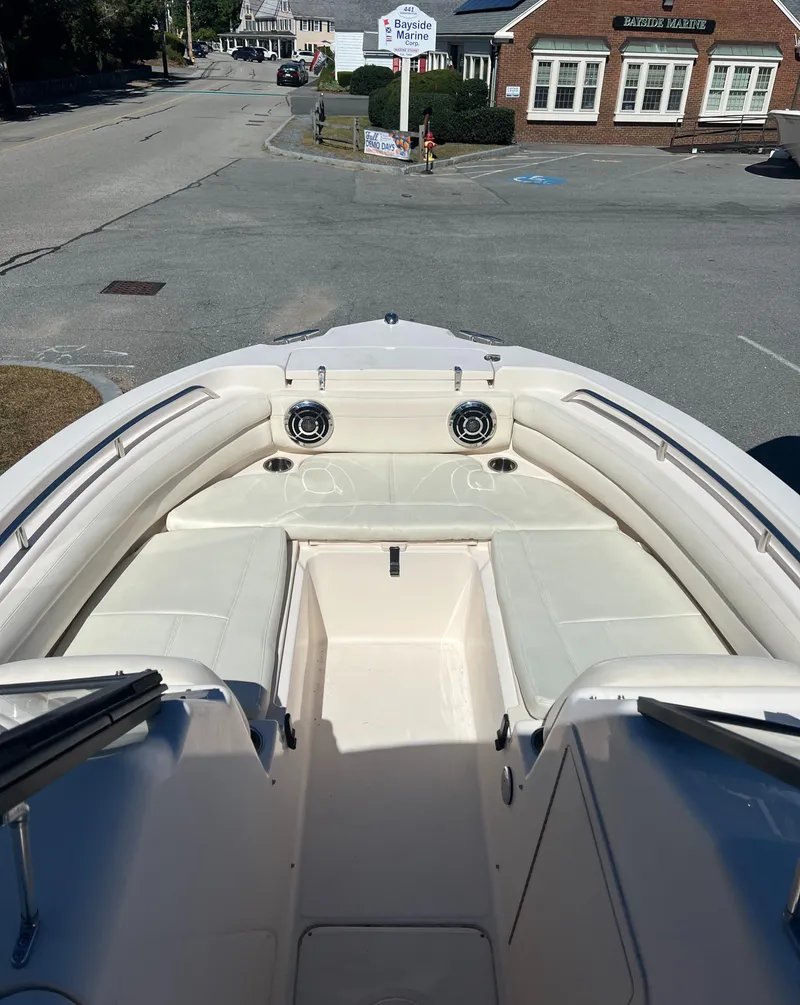 Slide: The Image of 2015 Grady-White 225 Freedom boat interior, street view in background. - 2