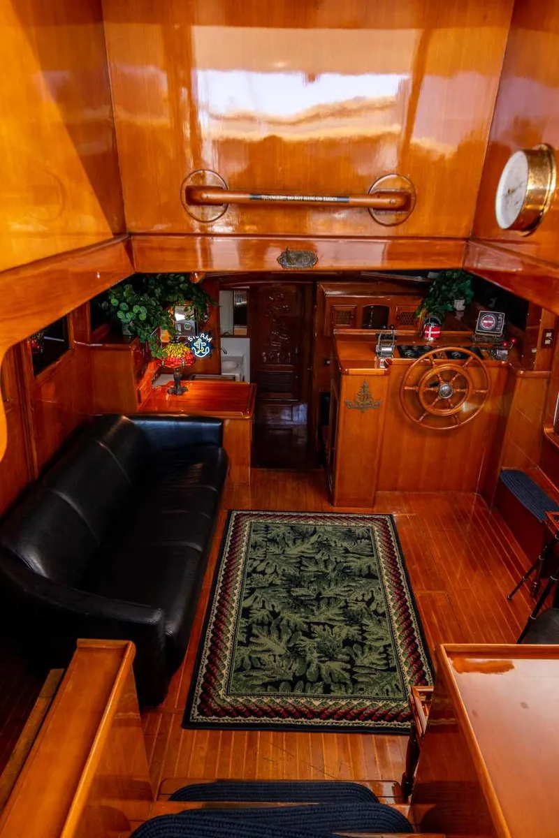Slide: The Image of Luxurious 1984 Marine Trader Aft Cabin Motor Yacht interior with wooden finish and elegant decor. - 22