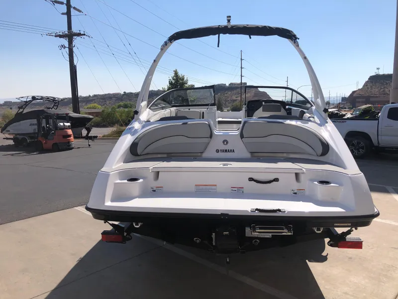 Slide: The Image of 2025 Yamaha Boats AR190, rear view, parked outdoors on a sunny day. - 11