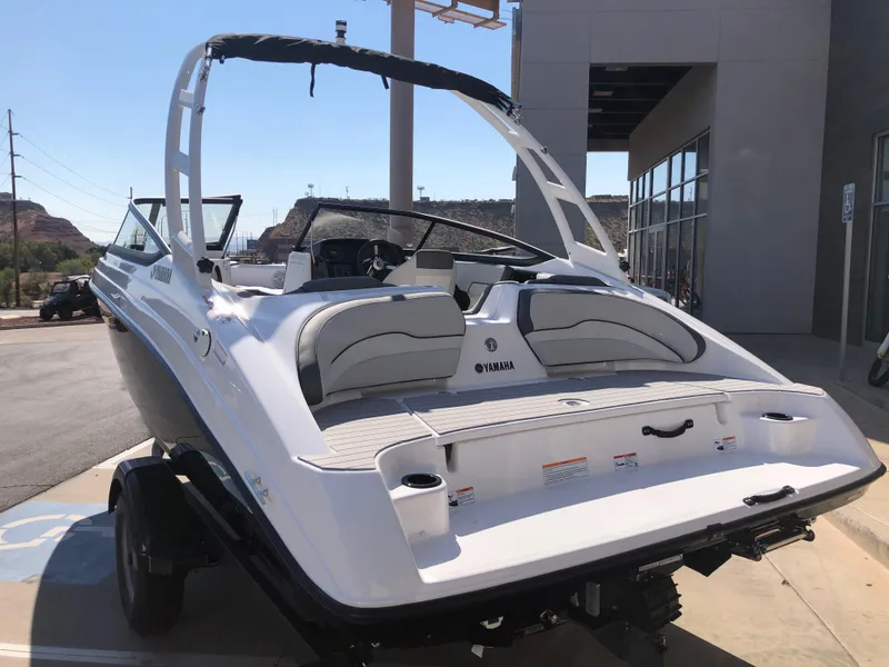 Slide: The Image of 2025 Yamaha Boats AR190, sleek white design, parked outdoors on a trailer. - 12