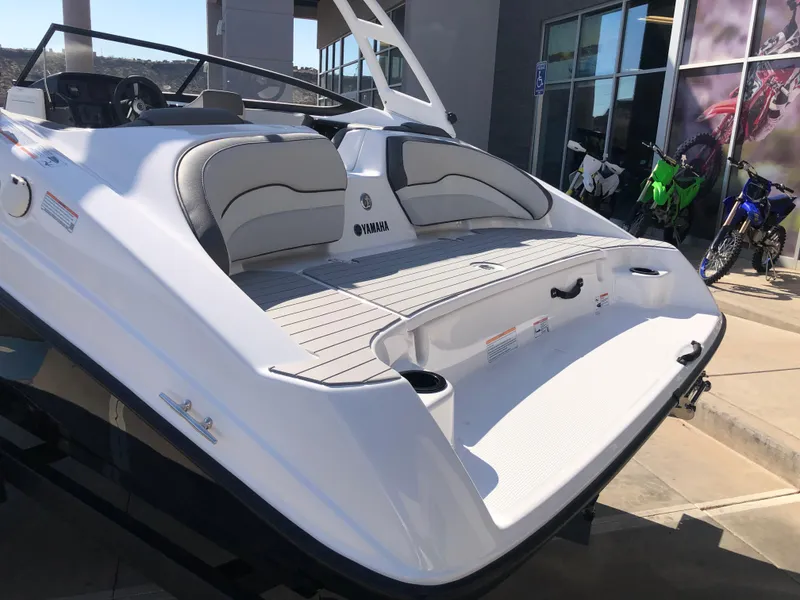 Slide: The Image of 2025 Yamaha Boats AR190, sleek white design, rear view, modern seating, outdoor display. - 14