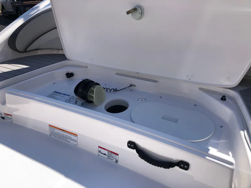 Slide: The Image of 2025 Yamaha Boats AR190 storage compartment with open lid and interior view. - 15