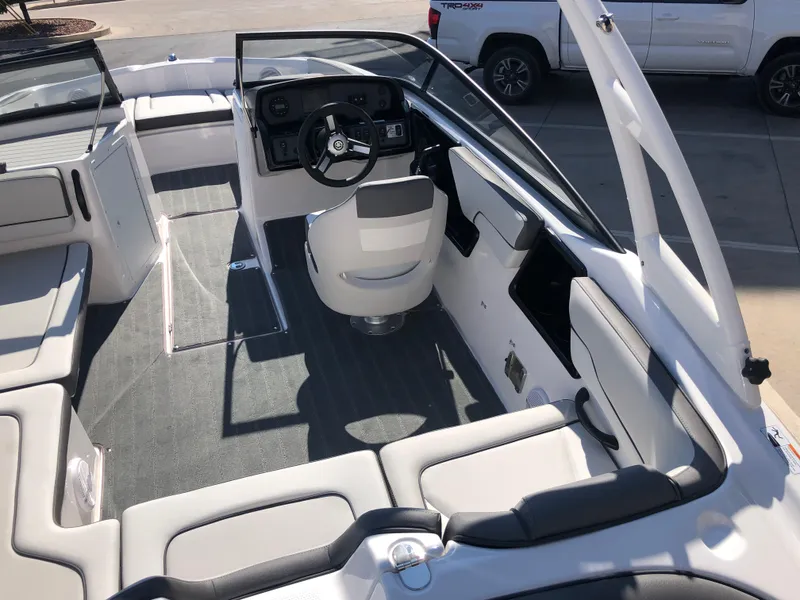Slide: The Image of 2025 Yamaha Boats AR190 interior with sleek seating and modern dashboard design. - 16