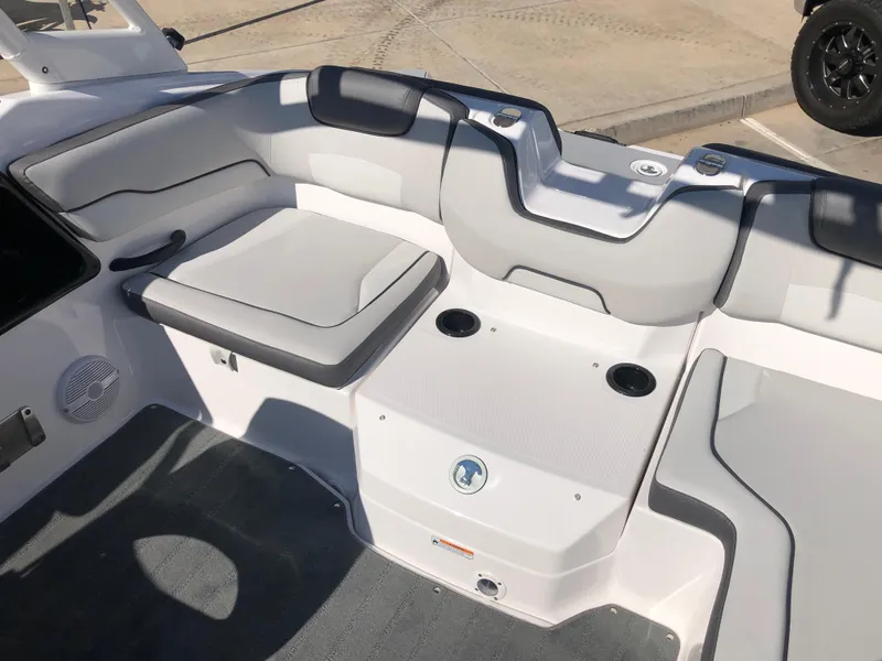 Slide: The Image of 2025 Yamaha Boats AR190 interior seating with gray cushions and cup holders. - 18