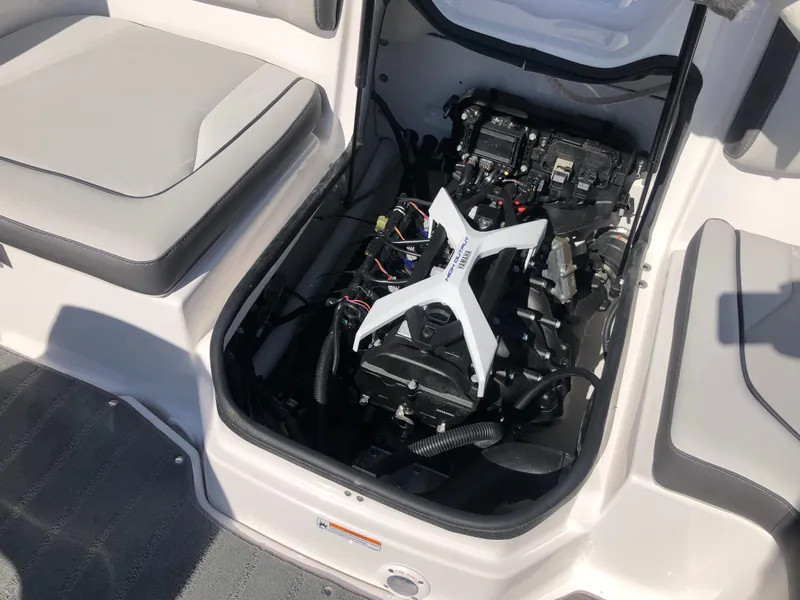 Slide: The Image of 2025 Yamaha Boats AR190 engine compartment with open hatch, showcasing internal components. - 19