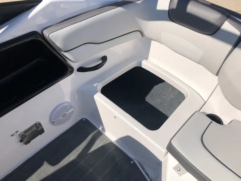 Slide: The Image of 2025 Yamaha Boats AR190 interior seating area with white and gray upholstery. - 23