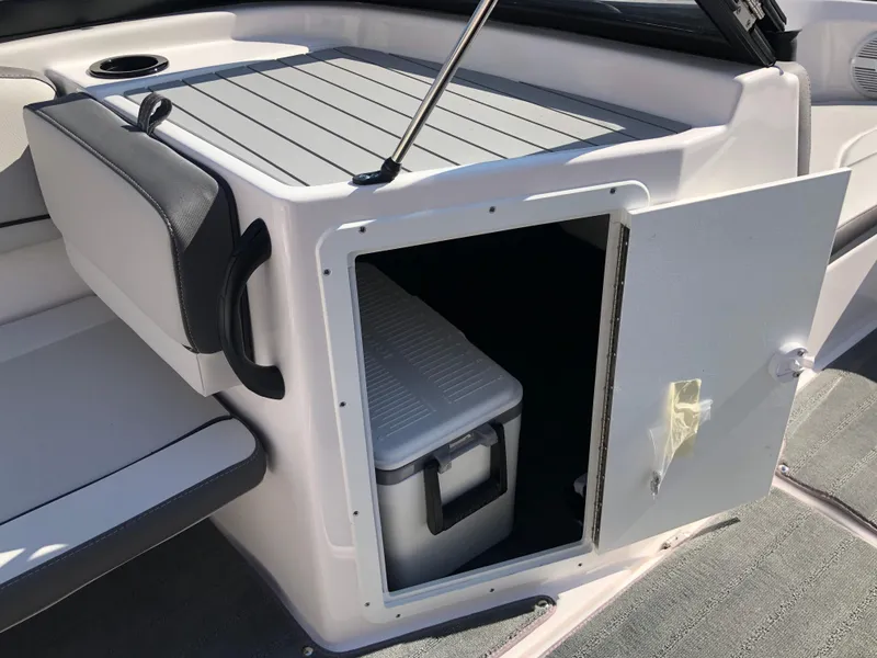 Slide: The Image of 2025 Yamaha Boats AR190 storage compartment with cooler inside. - 24