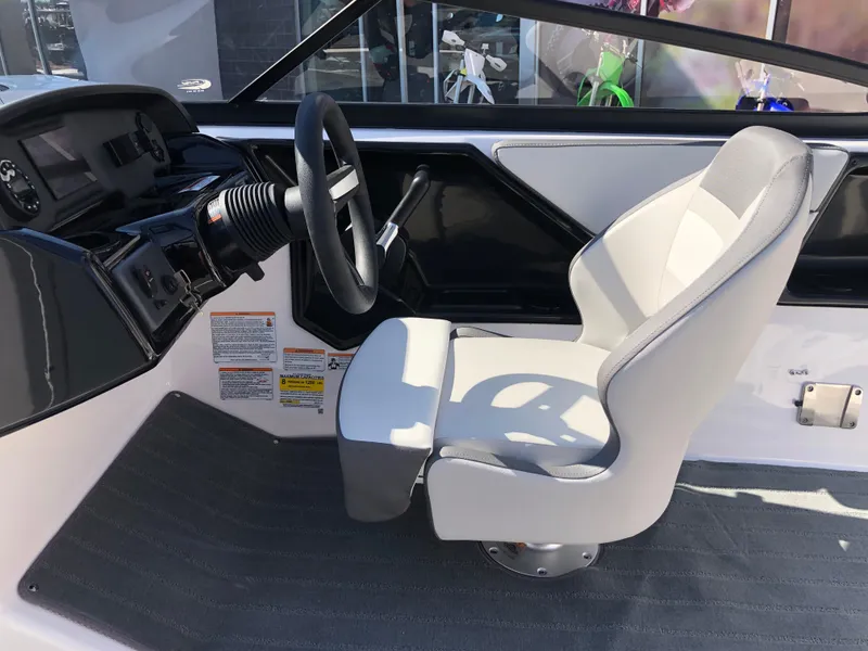 Slide: The Image of 2025 Yamaha Boats AR190 cockpit with steering wheel and captain's chair. - 26