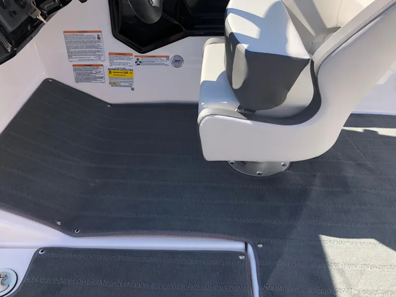 Slide: The Image of 2025 Yamaha Boats AR190 interior with gray flooring and white captain's chair. - 27