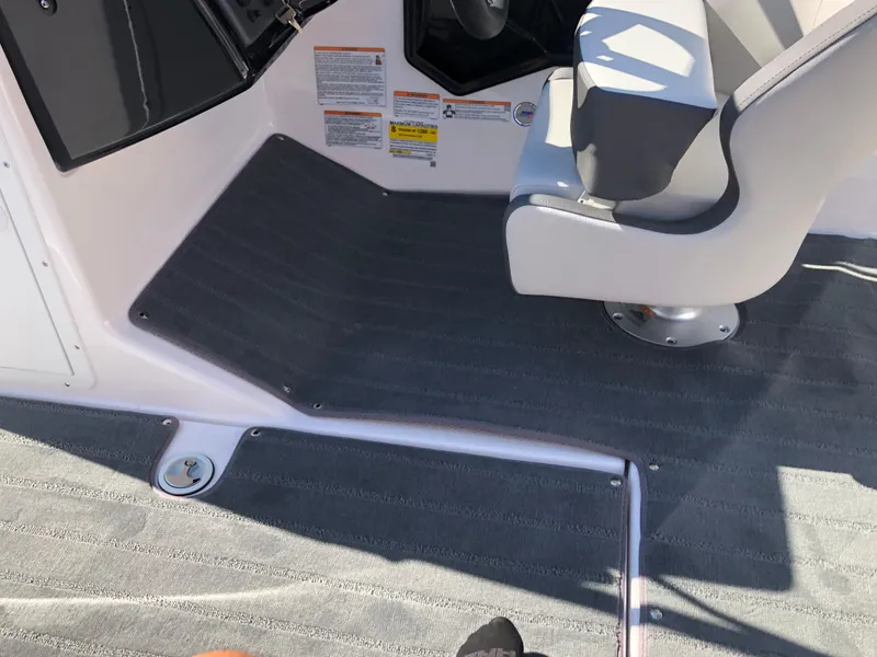 Slide: The Image of 2025 Yamaha Boats AR190 interior with gray flooring and seating. - 28