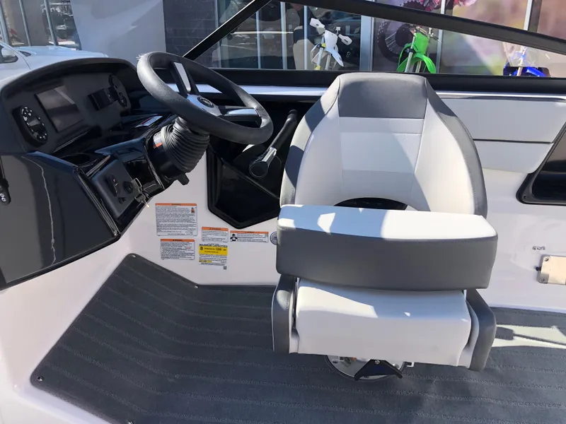 Slide: The Image of 2025 Yamaha Boats AR190 cockpit with steering wheel and captain's chair. - 29