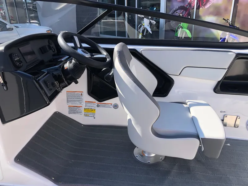 Slide: The Image of 2025 Yamaha Boats AR190 cockpit with steering wheel and captain's chair. - 30