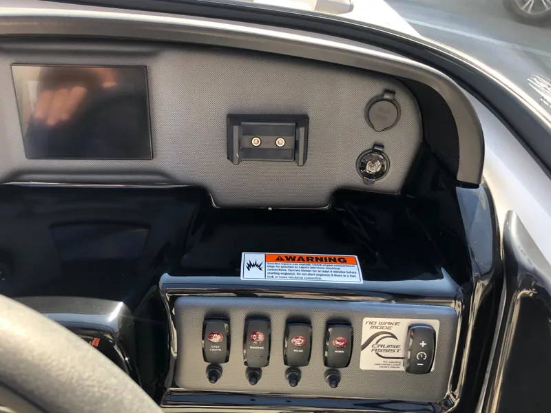 Slide: The Image of Dashboard of 2025 Yamaha Boats AR190 with control switches and warning label. - 32