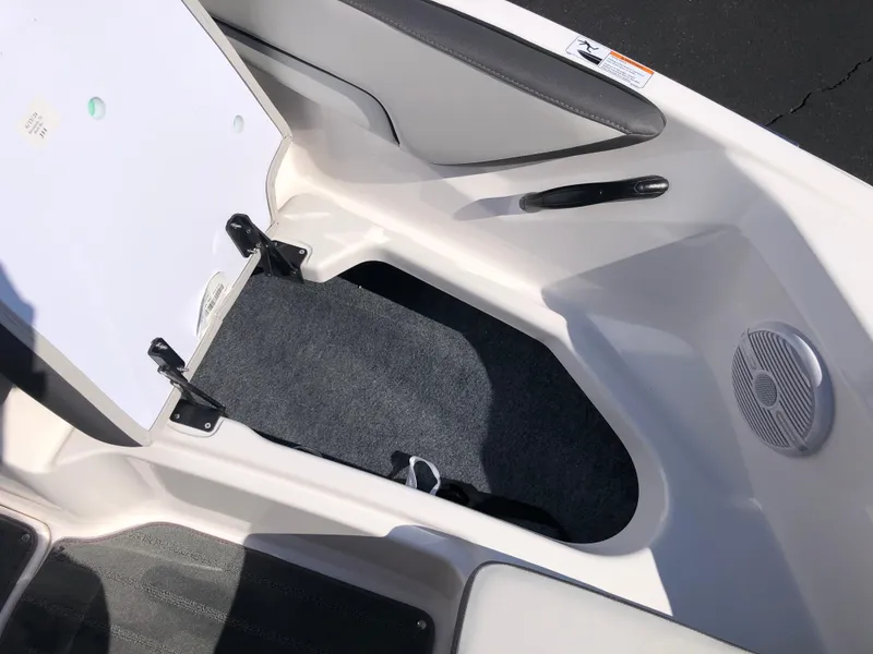 Slide: The Image of Interior view of 2025 Yamaha Boats AR190, featuring storage compartment and speaker. - 38