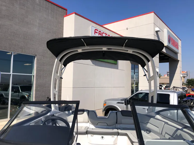 Slide: The Image of 2025 Yamaha AR190 boat with canopy at dealership exterior. - 43