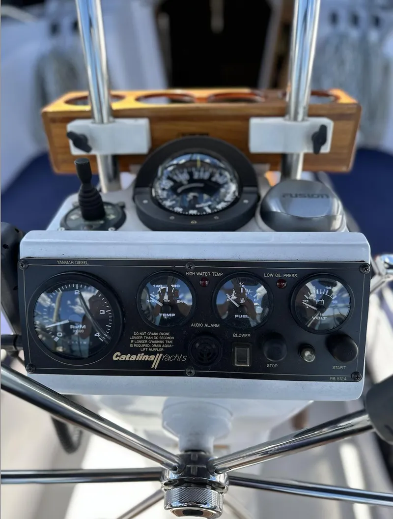 Slide: The Image of Cockpit instruments of a 2013 Catalina 355 sailboat, featuring navigation and control gauges. - 11