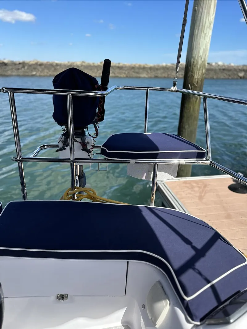 Slide: The Image of Catalina 355 sailboat cockpit with blue cushions, docked by calm waters, 2013 model. - 16