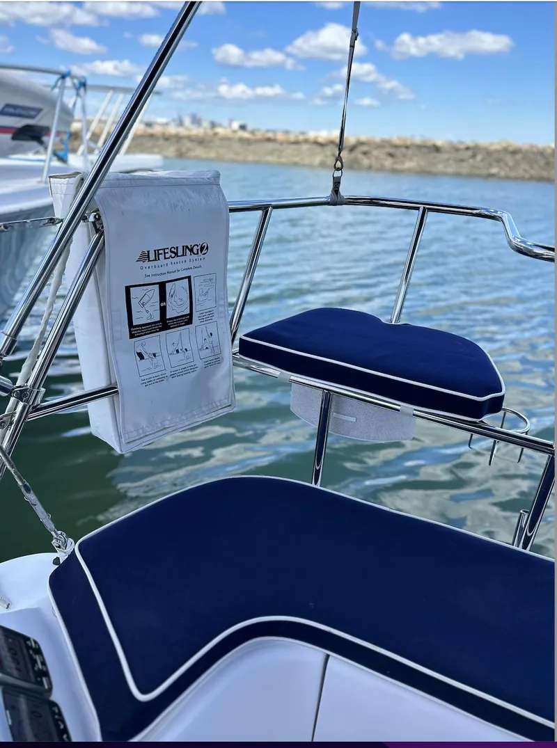 Slide: The Image of Catalina 355 sailboat, 2013 model, featuring blue cushioned seating and a Lifesling safety device. - 17
