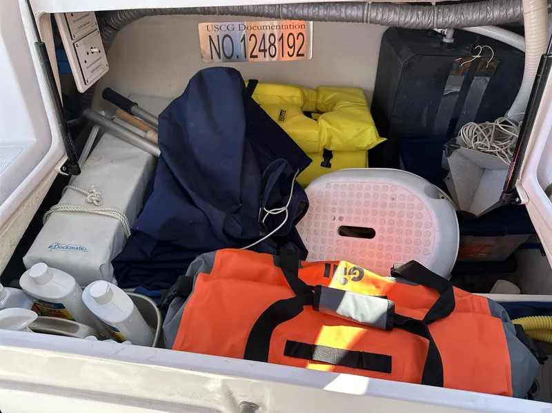 Slide: The Image of Storage compartment of a 2013 Catalina 355 sailboat with life jackets and boating gear. - 18