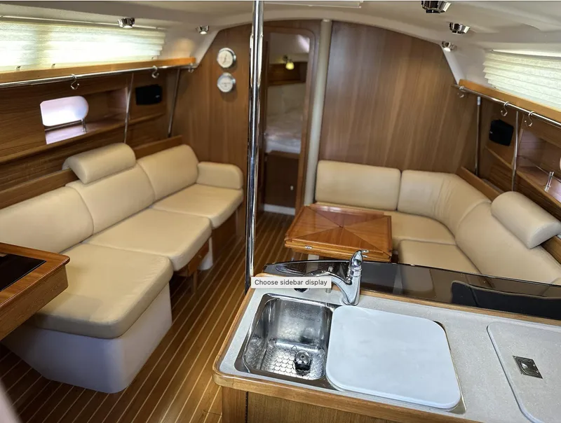 Slide: The Image of Luxurious interior of a 2013 Catalina 355 sailboat with elegant seating and wood finishes. - 19