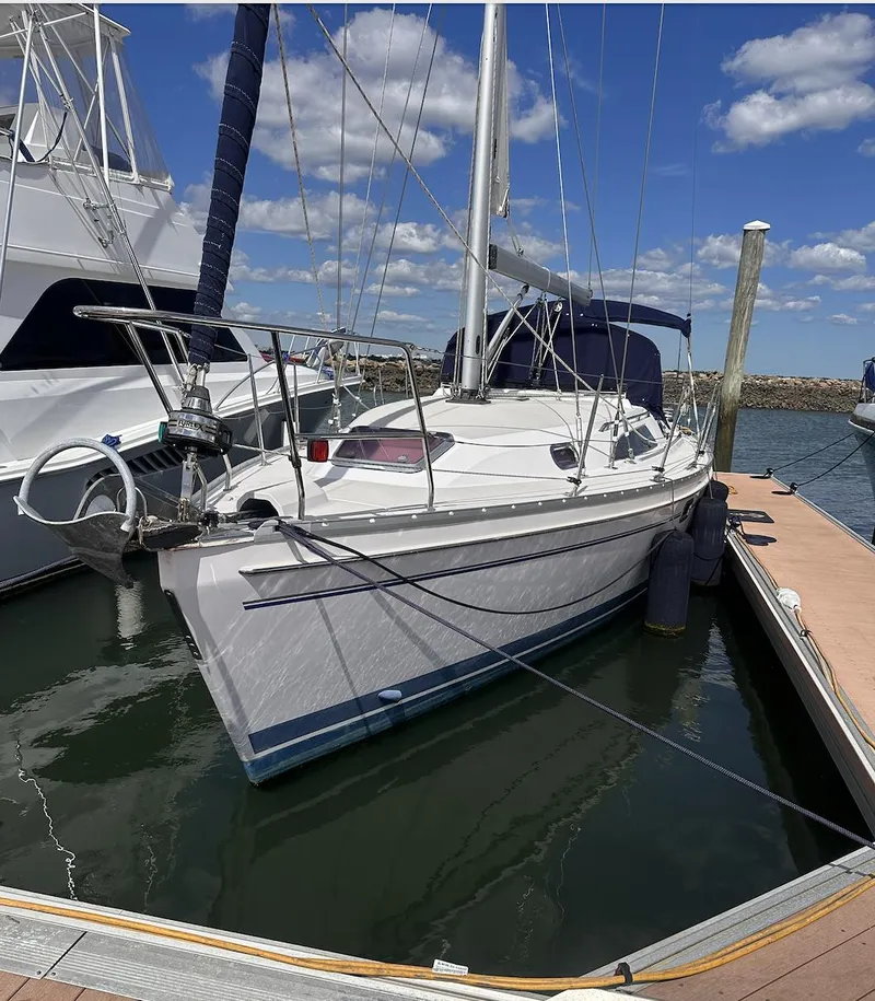 Slide: The Image of 2013 Catalina 355 sailboat docked at marina under blue sky. - 2