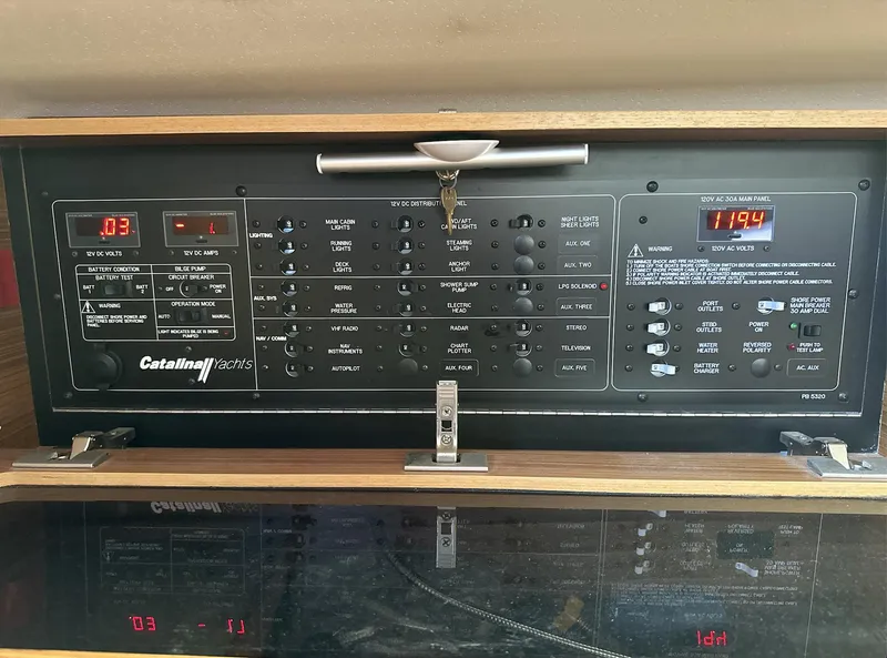 Slide: The Image of Control panel of a 2013 Catalina 355 yacht with various switches and digital displays. - 20