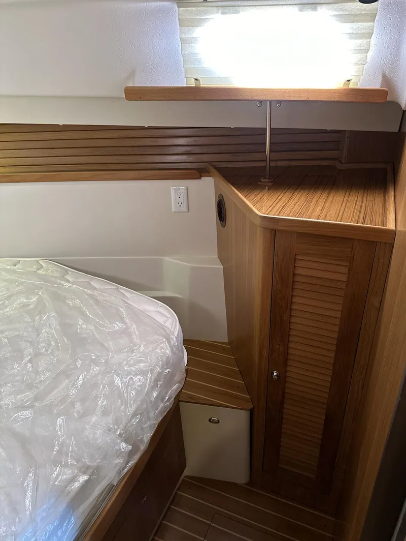 Slide: The Image of Interior cabin of a 2013 Catalina 355 sailboat with wooden cabinetry and bed. - 29