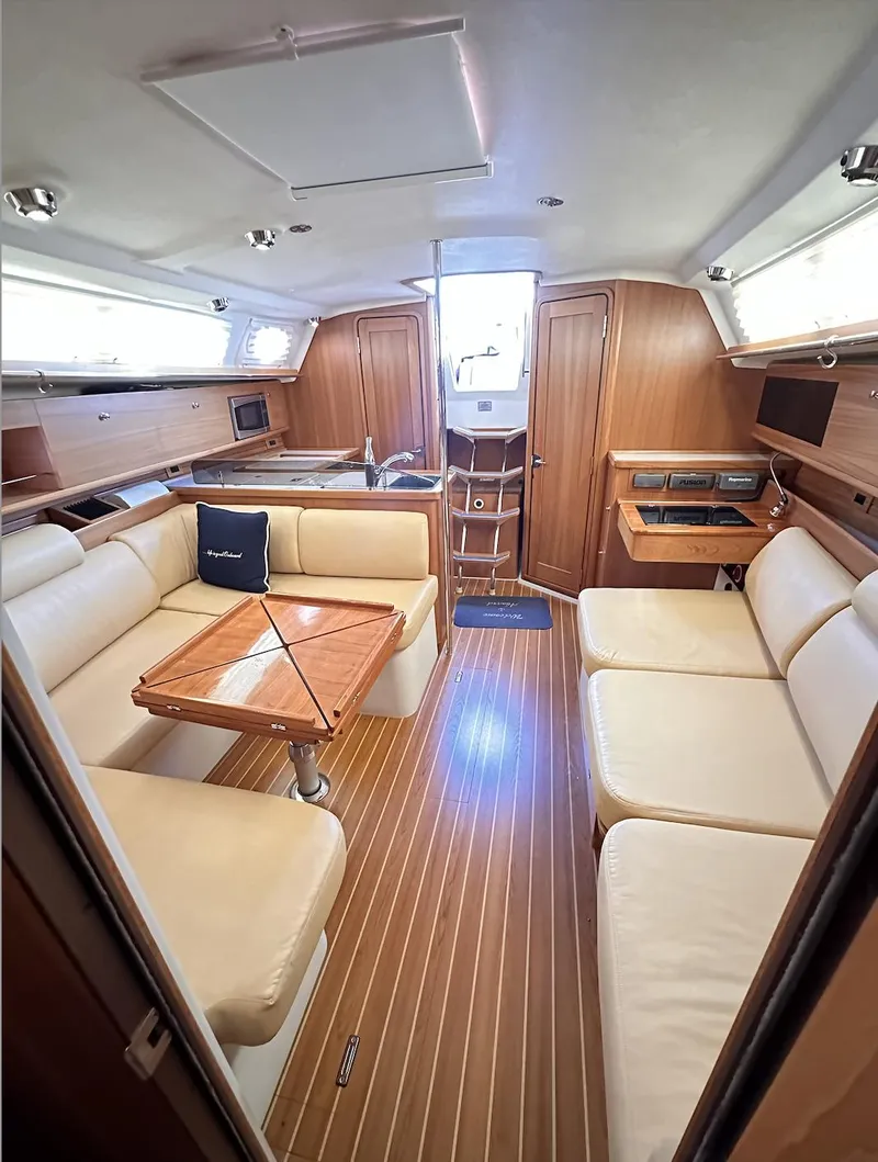 Slide: The Image of Luxurious interior of a 2013 Catalina 355 sailboat with elegant wood finishes. - 31