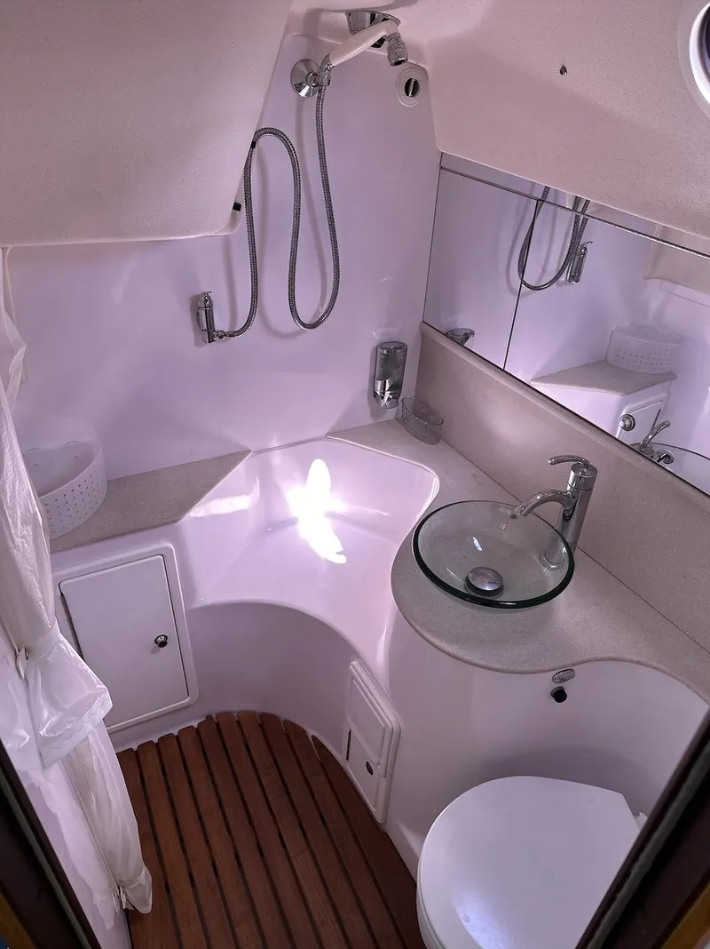 Slide: The Image of 2013 Catalina 355 yacht bathroom with modern fixtures and wooden flooring. - 32