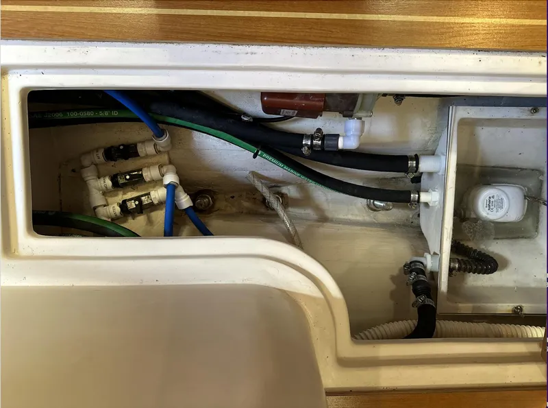 Slide: The Image of Interior plumbing of a 2013 Catalina 355 sailboat, showing pipes and fittings. - 33