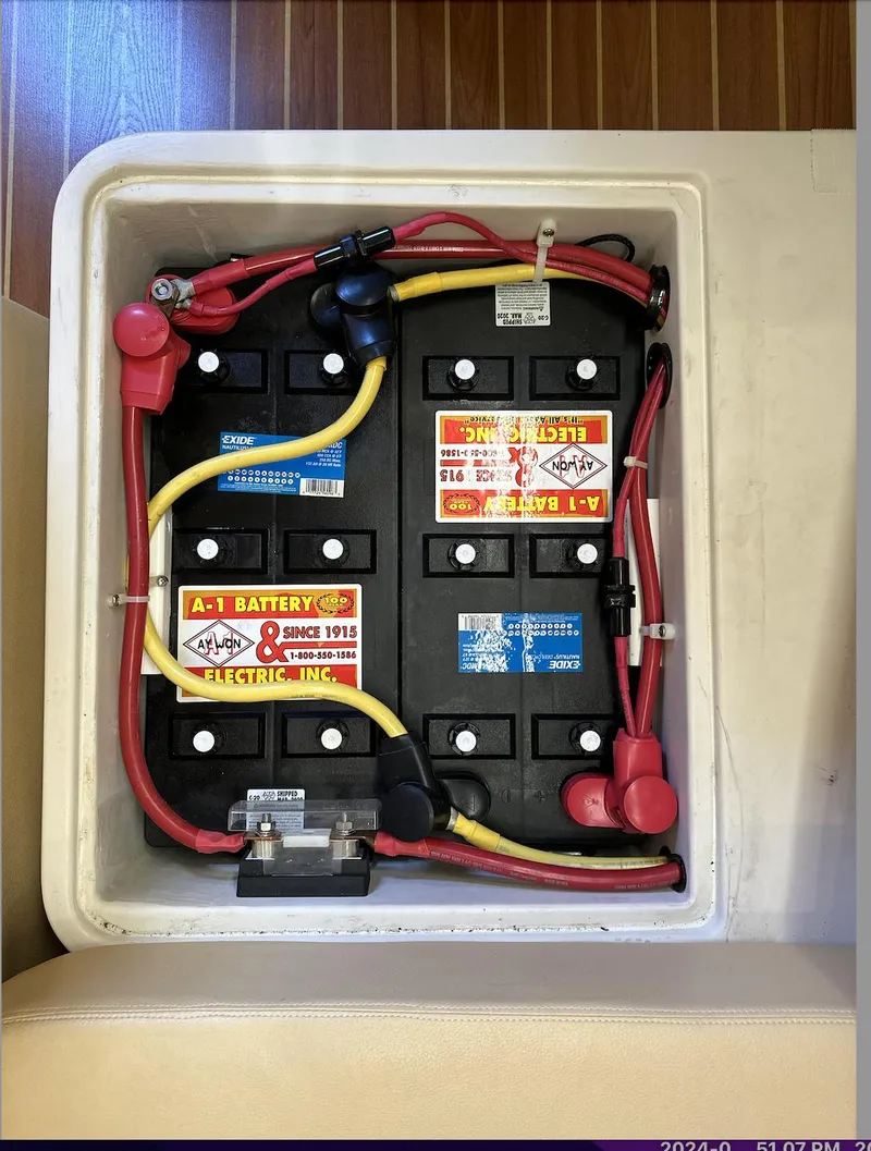 Slide: The Image of Battery compartment of a 2013 Catalina 355 sailboat with wiring and labels visible. - 34
