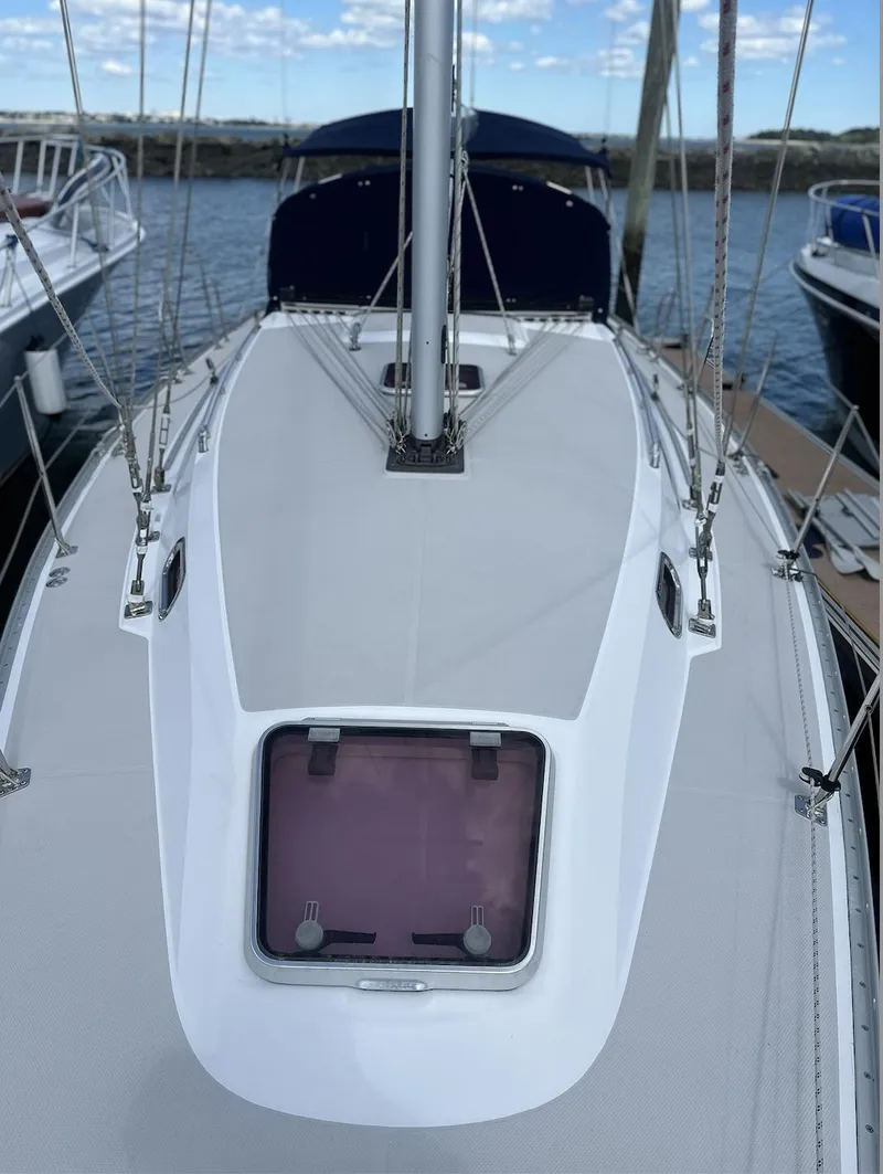 Slide: The Image of 2013 Catalina 355 sailboat deck view at marina, featuring sleek design and modern fittings. - 7