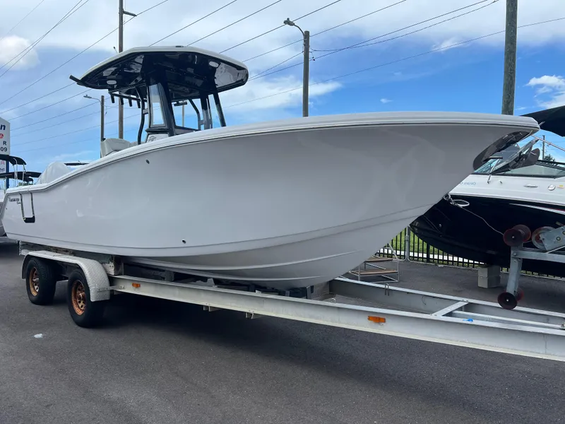 Slide: The Image of 2025 Tidewater 272 CC Adventure boat on trailer, ready for adventure. - 1