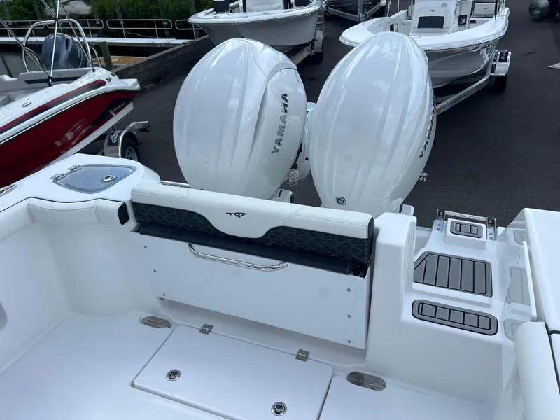 Slide: The Image of 2025 Tidewater 272 CC Adventure boat with dual Yamaha engines, rear seating, and deck view. - 10