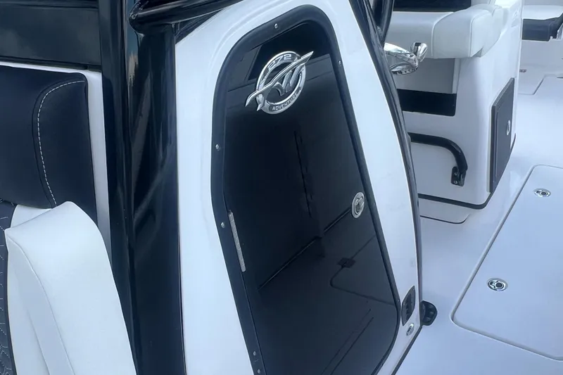 Slide: The Image of 2025 Tidewater 272 CC Adventure boat interior, featuring sleek black and white design. - 11