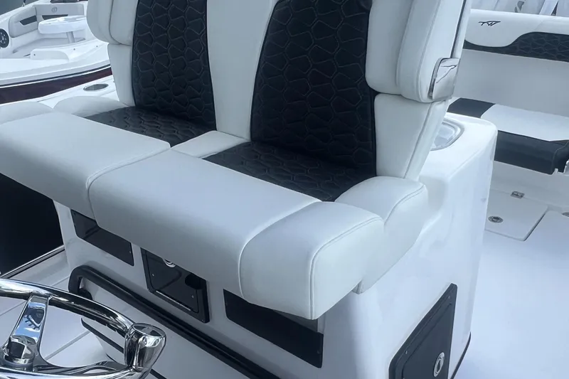 Slide: The Image of 2025 Tidewater 272 CC Adventure boat seating with black and white upholstery. - 13