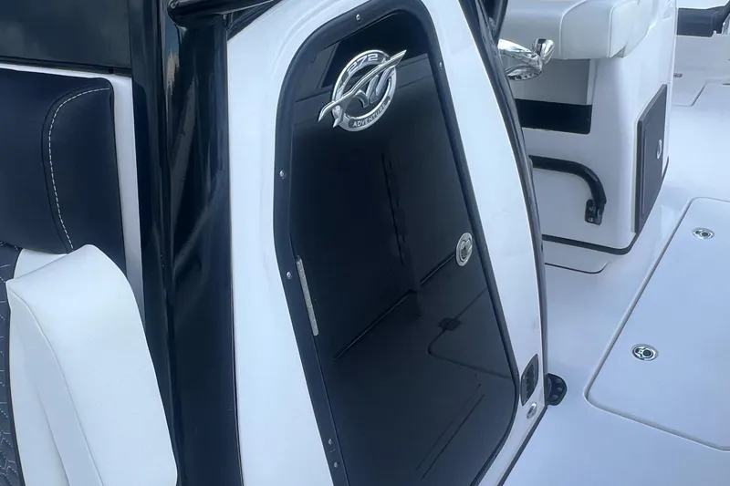 Slide: The Image of 2025 Tidewater 272 CC Adventure boat interior with sleek black and white design. - 15