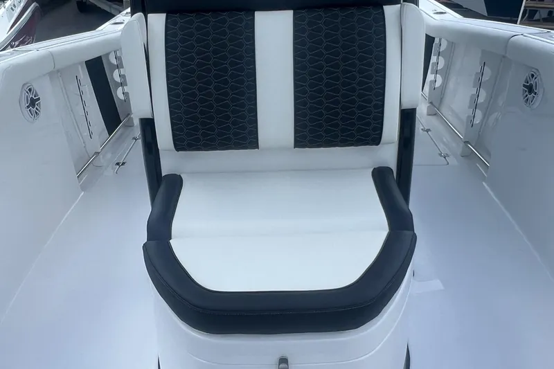 Slide: The Image of 2025 Tidewater 272 CC Adventure boat seating with black and white upholstery. - 16