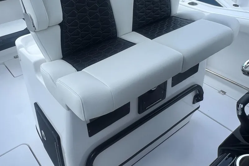 Slide: The Image of 2025 Tidewater 272 CC Adventure boat seating with black and white upholstery. - 17