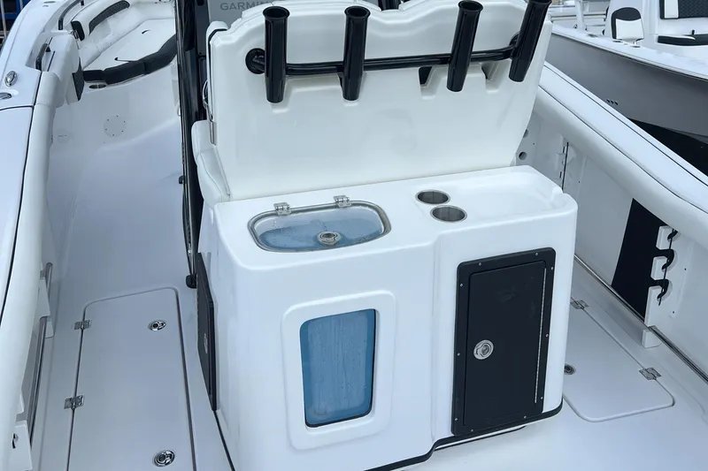 Slide: The Image of Tidewater 272 CC Adventure 2025 boat interior with fishing rod holders and storage compartments. - 18