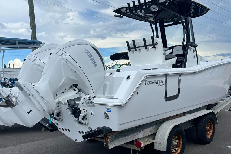 Slide: The Image of 2025 Tidewater 272 CC Adventure boat with dual Yamaha engines on a trailer. - 5