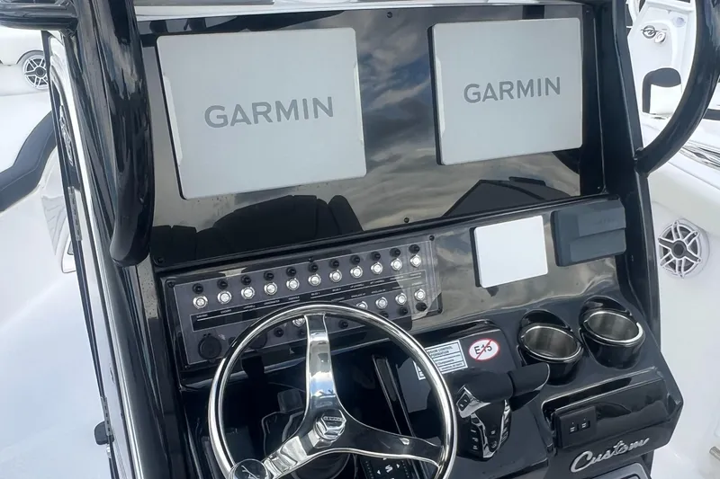 Slide: The Image of 2025 Tidewater 272 CC Adventure boat dashboard with dual Garmin displays and steering wheel. - 6