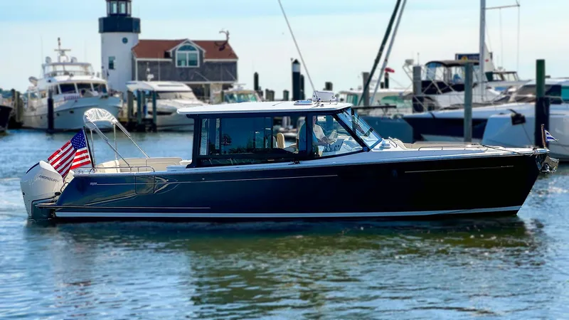 Slide: The Image of 2024 MJM 3 boat docked in marina with American flag. - 0