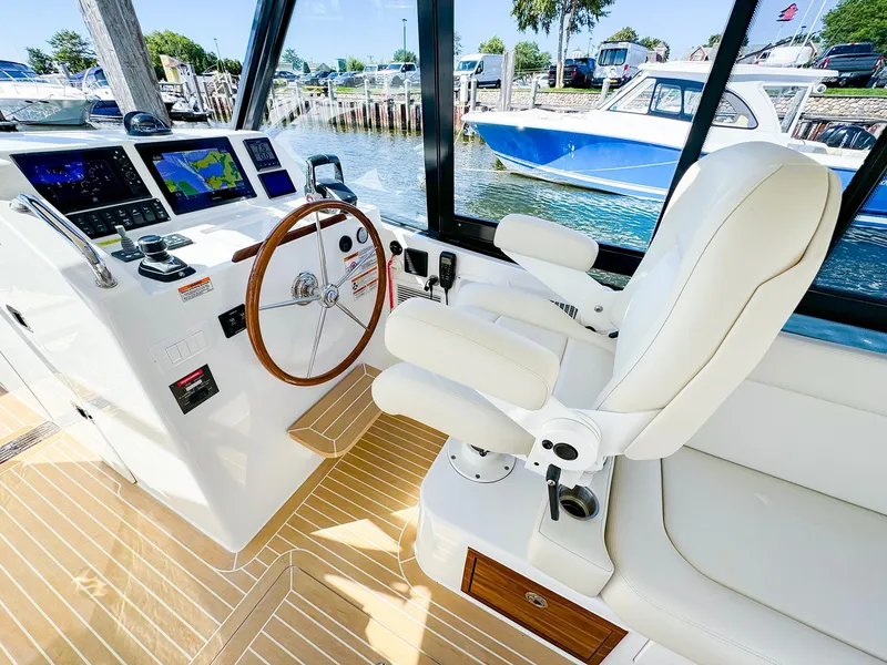 Slide: The Image of 2024 MJM 3 boat interior with helm, steering wheel, and navigation screens. - 10