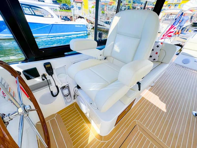 Slide: The Image of Luxurious captain's chair on 2024 MJM 3 boat, featuring sleek design and modern controls. - 11